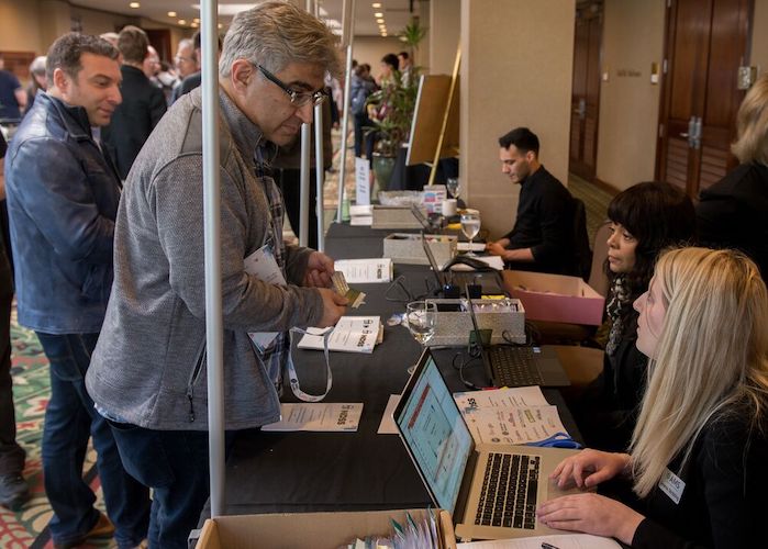 a man talking to a woman at registration desk