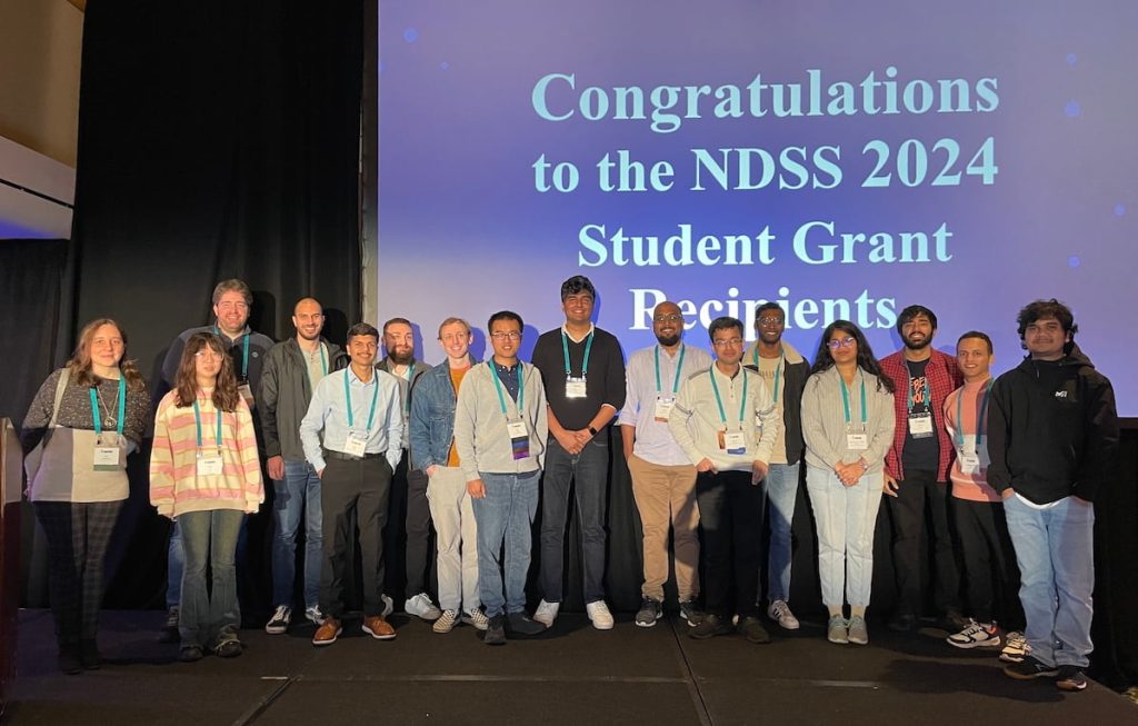 Students proudly standing together on stage