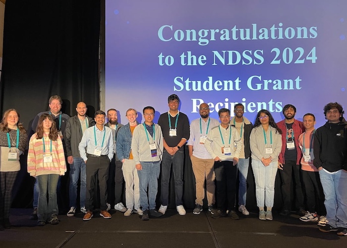 Students proudly standing together on stage